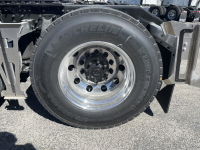 Volvo VNL64T860 wheel and Michelin tire assembly showing tire sidewall; hub and lug nuts visible.