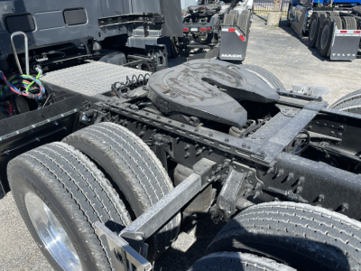 Volvo VNL64T860 chassis showing dual rear axles and fifth wheel with visible truck components.