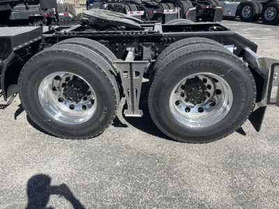 Dual rear wheels on a Volvo truck chassis showing tires, wheels, and frame with hydraulic lines and mounting brackets visible.