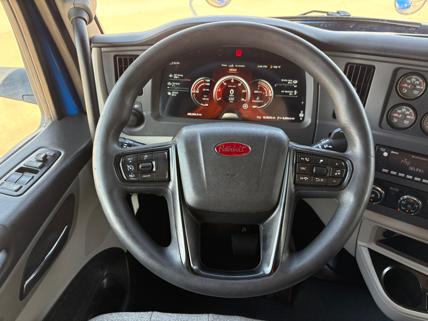 Peterbilt 579 interior steering wheel and dashboard view showing instrument cluster and steering controls