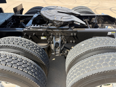 Peterbilt 579 tractor rear view showing fifth wheel coupling, dual rear axles, and drivetrain components