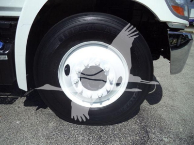 Wheel close-up showing white rim and tire on a Hino 268A dump truck.