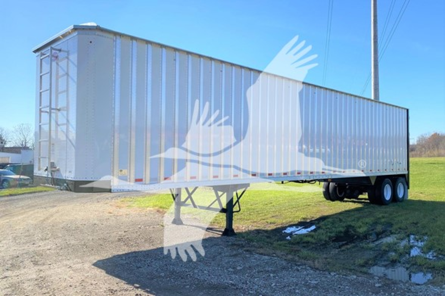 Trailer side view showing a Dorsey walking floor trailer with tandem axles and front landing gear.