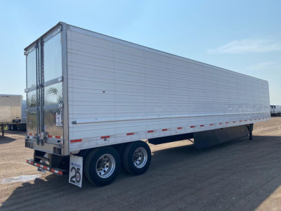 Trailer side view showing refrigerated utility reefer trailer with silver exterior and dual rear axles.