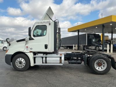 Freightliner Cascadia126 truck cab and chassis side view showing clean white cab and exposed fifth wheel area