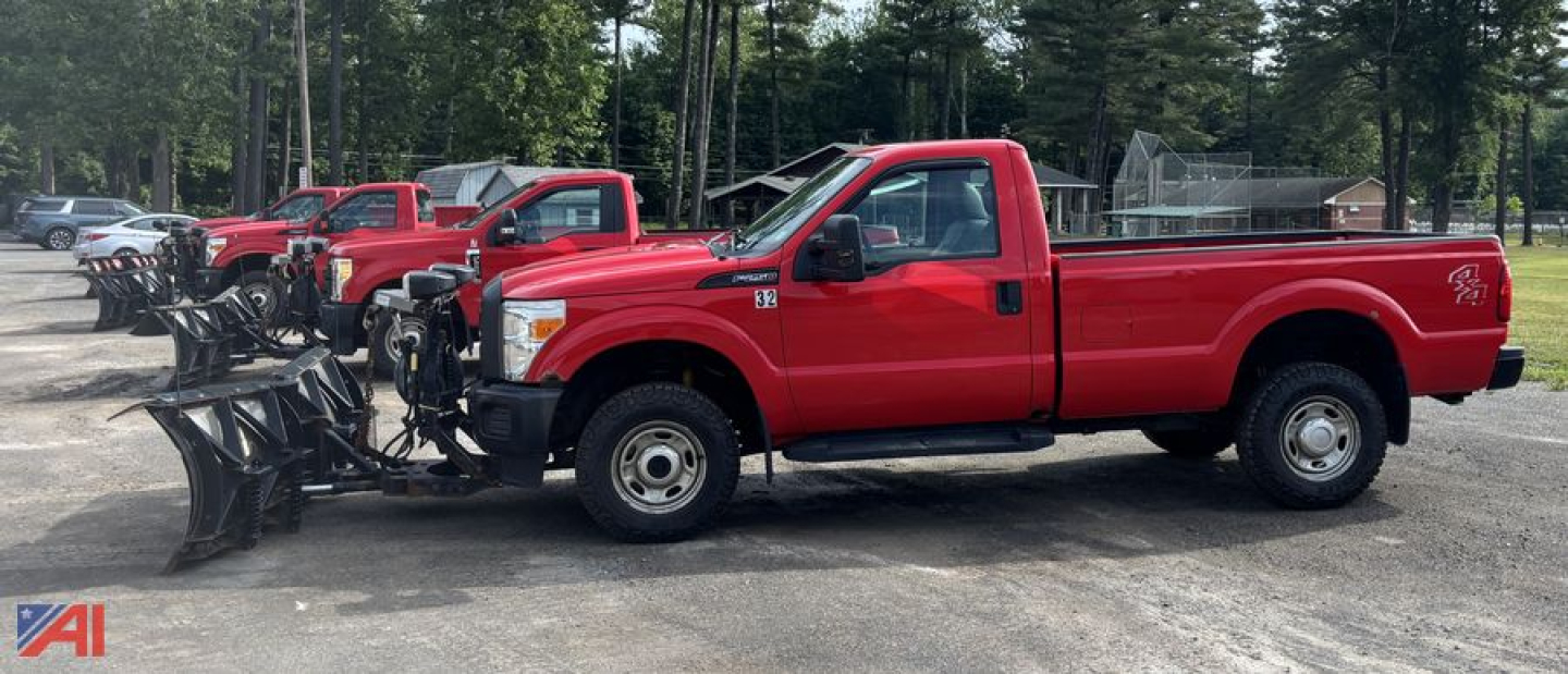 Ford F-250 Super Duty pickup with plow attachment mounted on front, red color, side view.