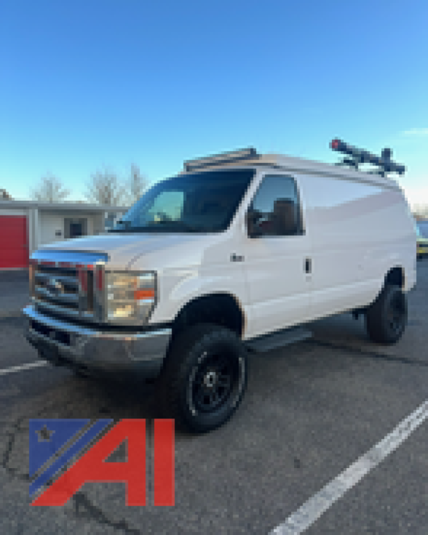 Ford E-350 cargo van in white, side view, with roof equipment rack, ladder rack, and raised suspension.