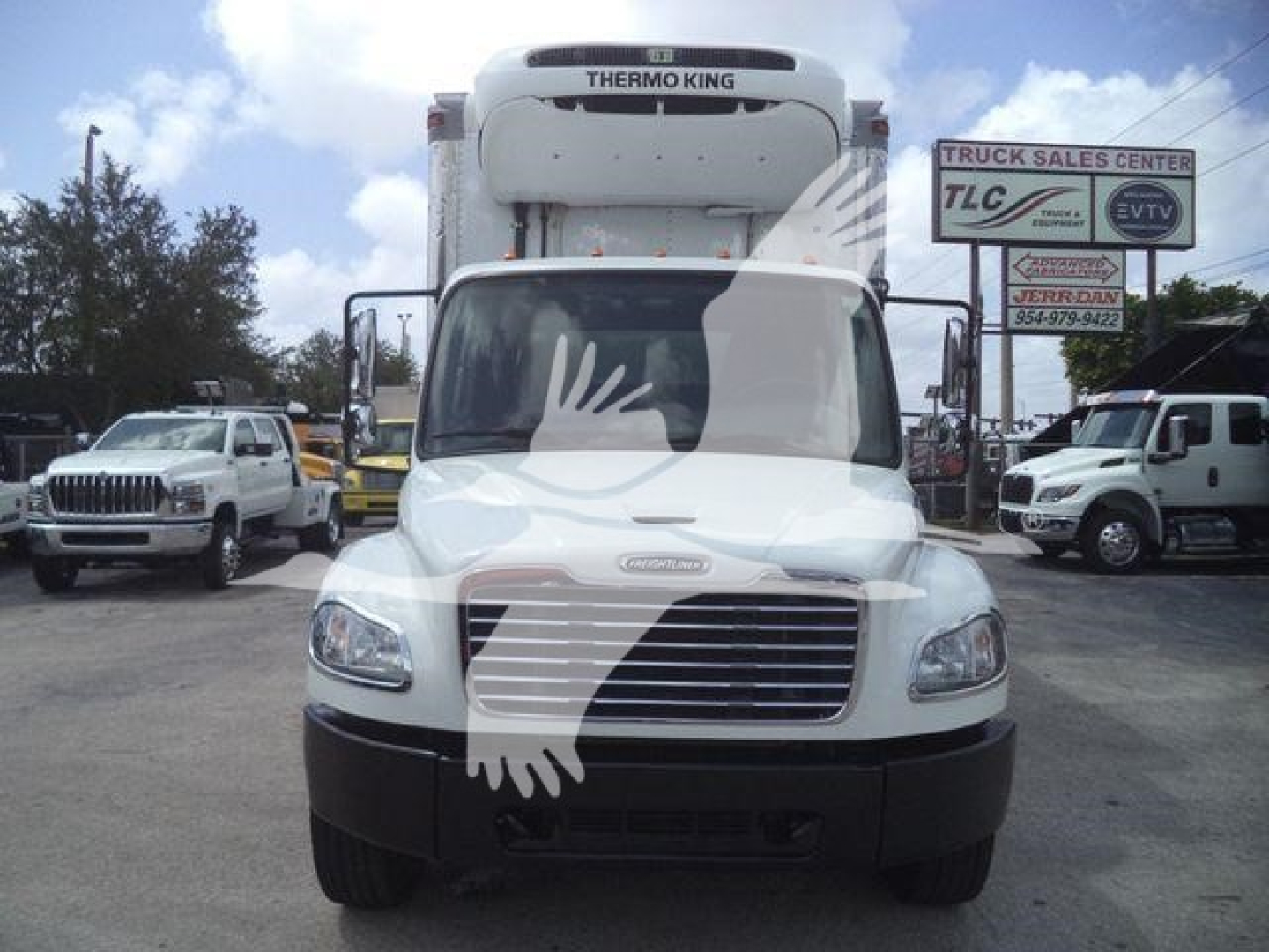 Freightliner M2 106 box truck front view with Thermo King unit on cab roof and dealership lot in background.