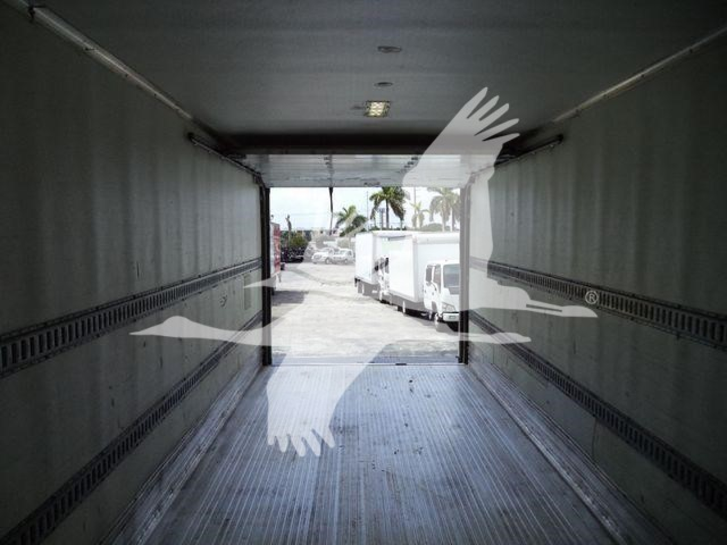 Interior view of Freightliner M2 106 cargo trailer/truck box showing empty aluminum cargo area with open rear doors and loading area.