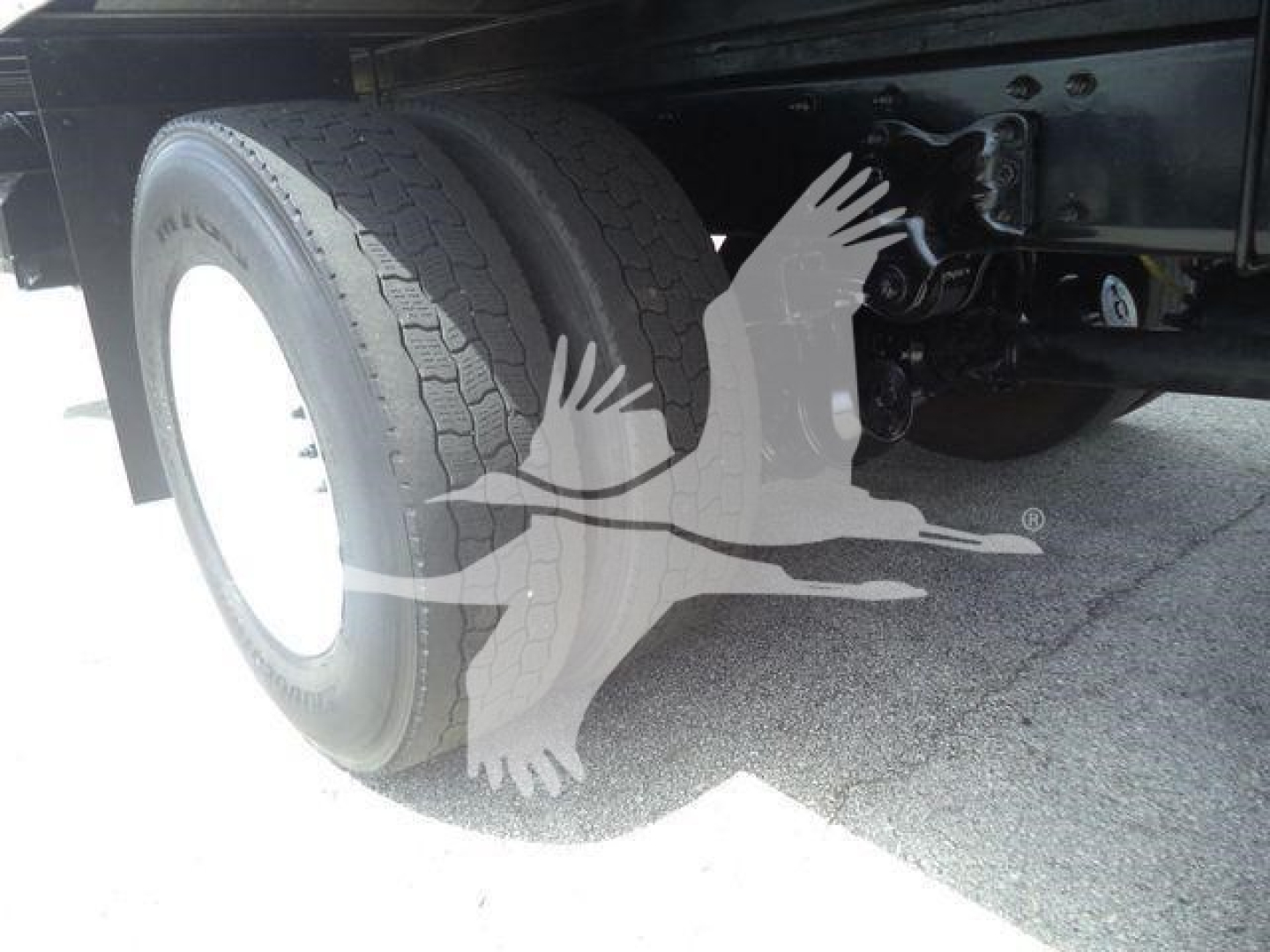 Freightliner M2 106 truck rear wheel and chassis view showing dual rear tires and undercarriage components.