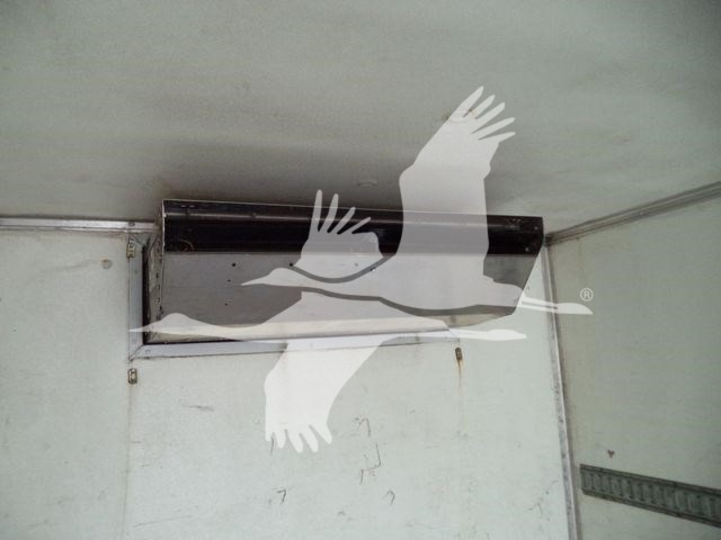 Freightliner M2 106 truck cargo area showing overhead vent and interior wall with metal trim.