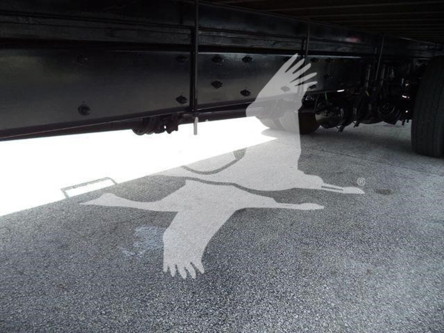 Freightliner M2 106 truck undercarriage alongside box truck frame showing chassis components and underside.