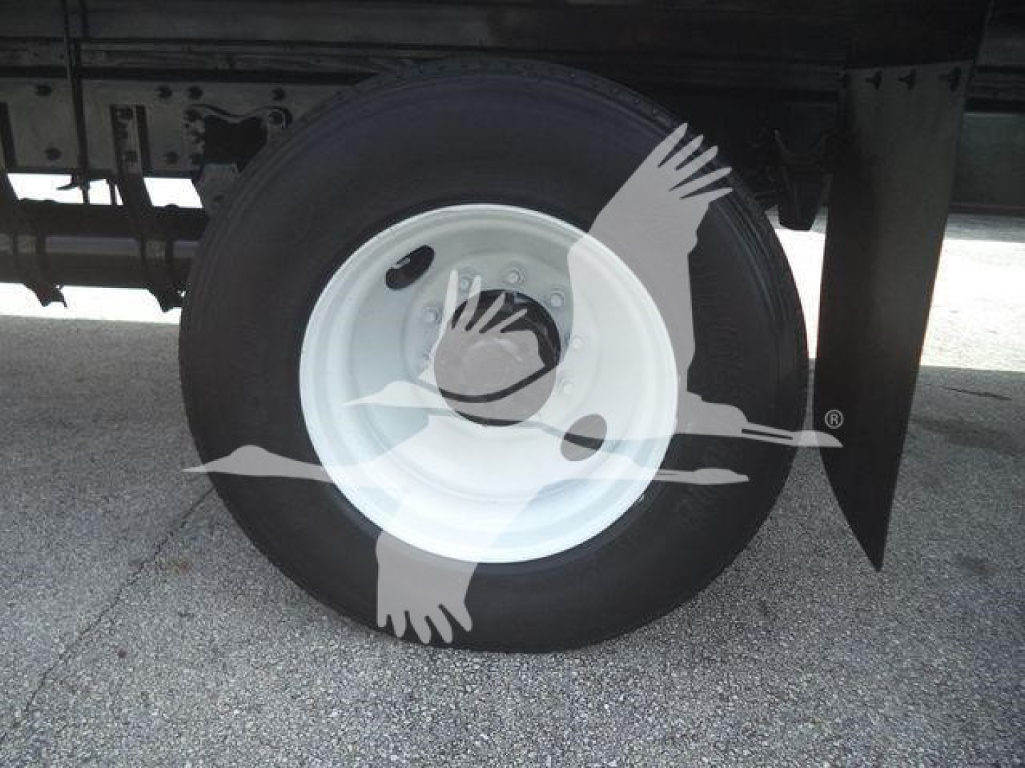Truck wheel on Freightliner M2 106 used box truck showing white steel rim and black tire