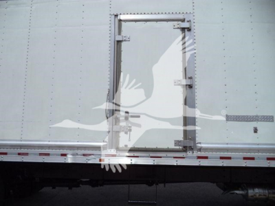 Truck side show a rectangular access door on box body with metal hinges and latch, Freightliner M2 106, stock image quality.