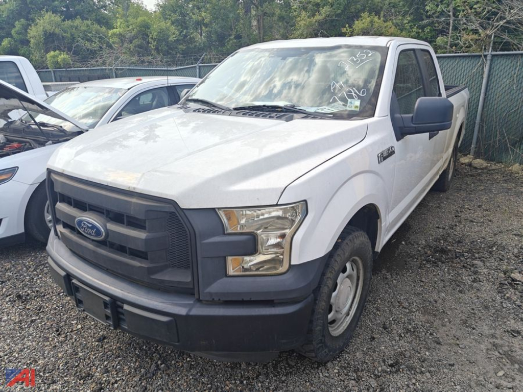 Ford F-150 extended cab pickup truck front-left view showing front grille, headlights, and side mirror.