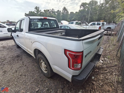 Ford F-150 extended cab pickup truck with bed cover and tailgate in view, white exterior, two-door extended cab, rear quarter and tail lights visible.