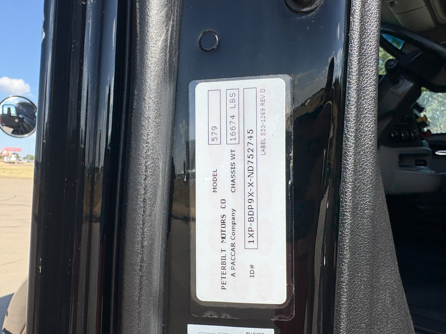 Peterbilt 579 cab door VIN plate with model and chassis ID; visible text includes 'PETERBILT MOTORS CO', 'MODEL', 'CHASSIS', and serial numbers on a vertical sticker.