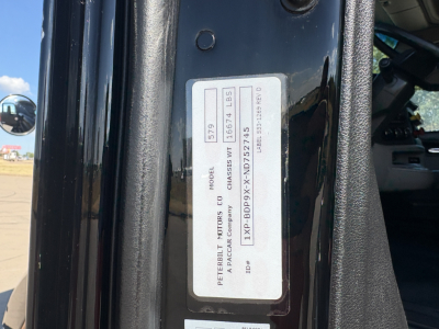 Peterbilt 579 cab door VIN plate with model and chassis ID; visible text includes 'PETERBILT MOTORS CO', 'MODEL', 'CHASSIS', and serial numbers on a vertical sticker.