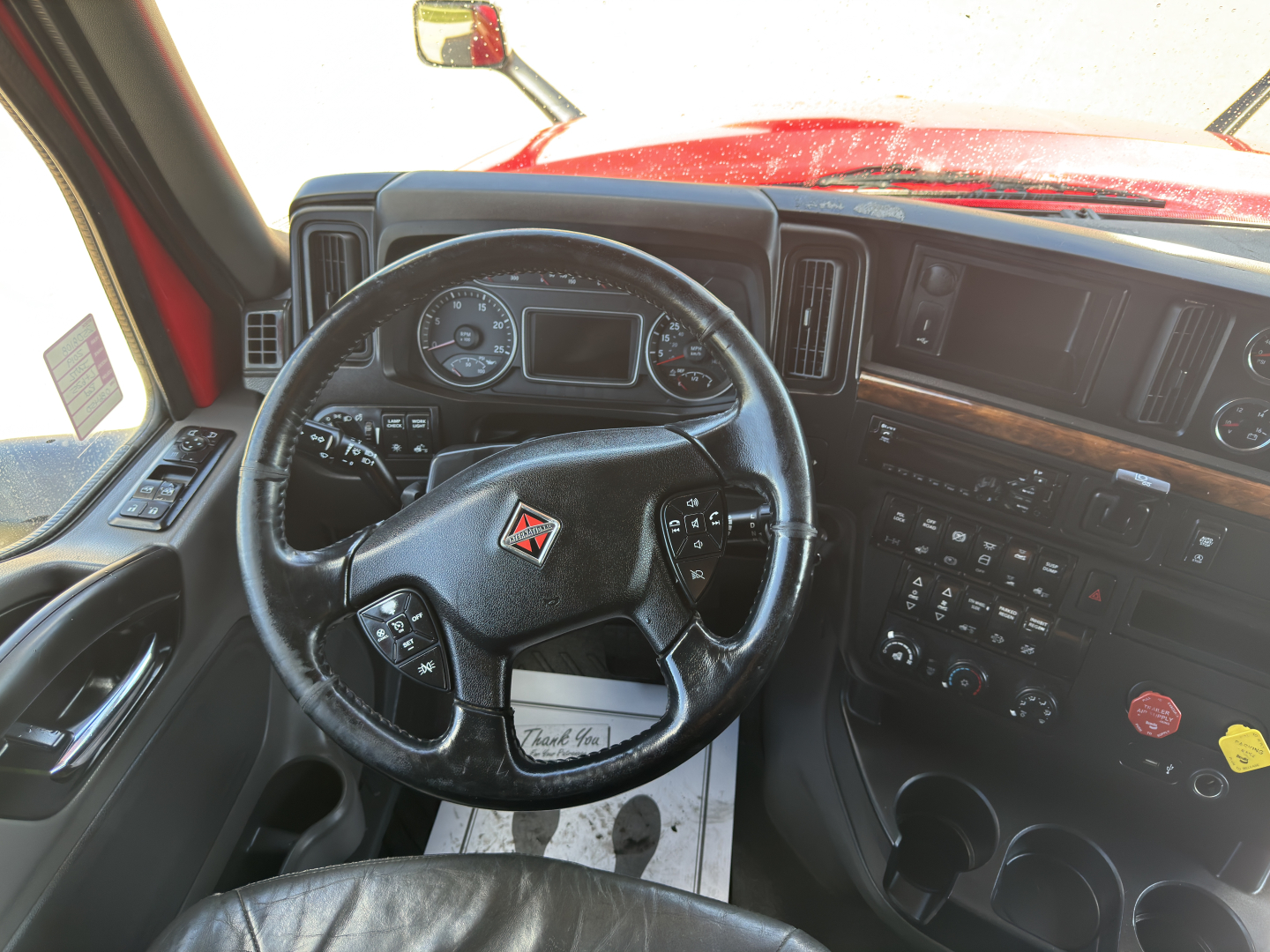 Interior of a 2019 International LT625 truck cab with steering wheel and dashboard visible