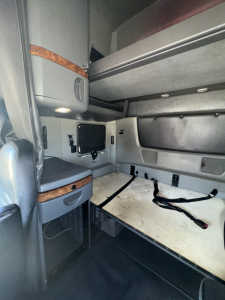 Cabin area of a 2019 International LT625 sleeper with bunk bed area and storage compartments visible.
