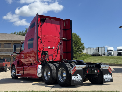 Truck cab and rear chassis of a red 2019 International LT625 sleeper tractor seen from the rear-left side showing dual rear axles and fifth-wheel chassis.