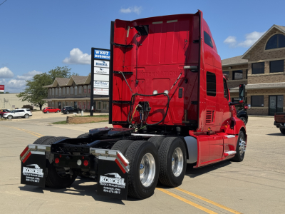 Truck rear and side view showing red 2019 International LT625 sleeper tractor with dual rear axles and fifth wheel.