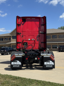 Truck rear view showing red sleeper cab, chassis, and dual mud flaps with Kordell logos; tail lights and rear bumper visible.