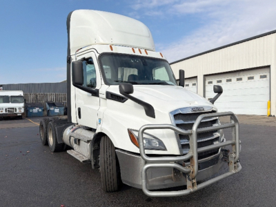 Truck cab and front view of a white 2020 Freightliner Cascadia 116 daycab, with grille guard, in-service condition.