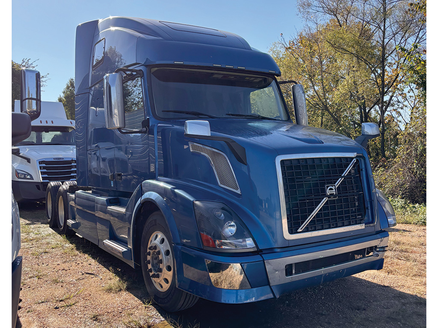 Volvo VNL 780 cab/front view showing blue exterior and grille badge.