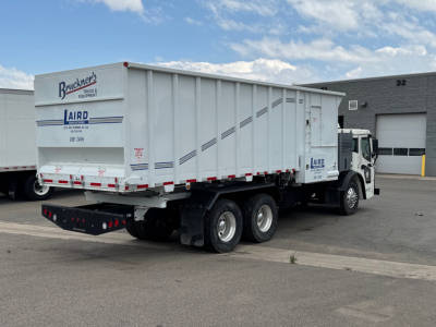 Truck tractor with dump trailer showing side and rear, Mack LR64 BE with Bruecker’s Truck & Equipment branding and AIRD logo on trailer
