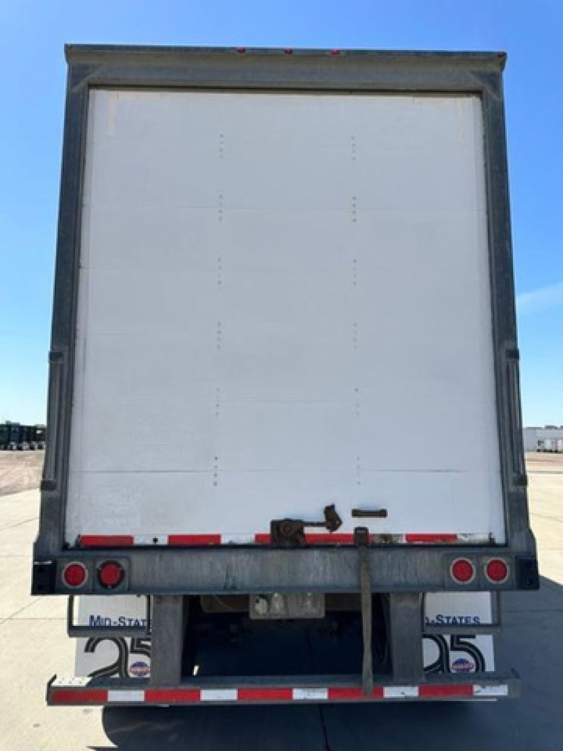 Rear view of a white Wabash van trailer showing back doors and bumper.