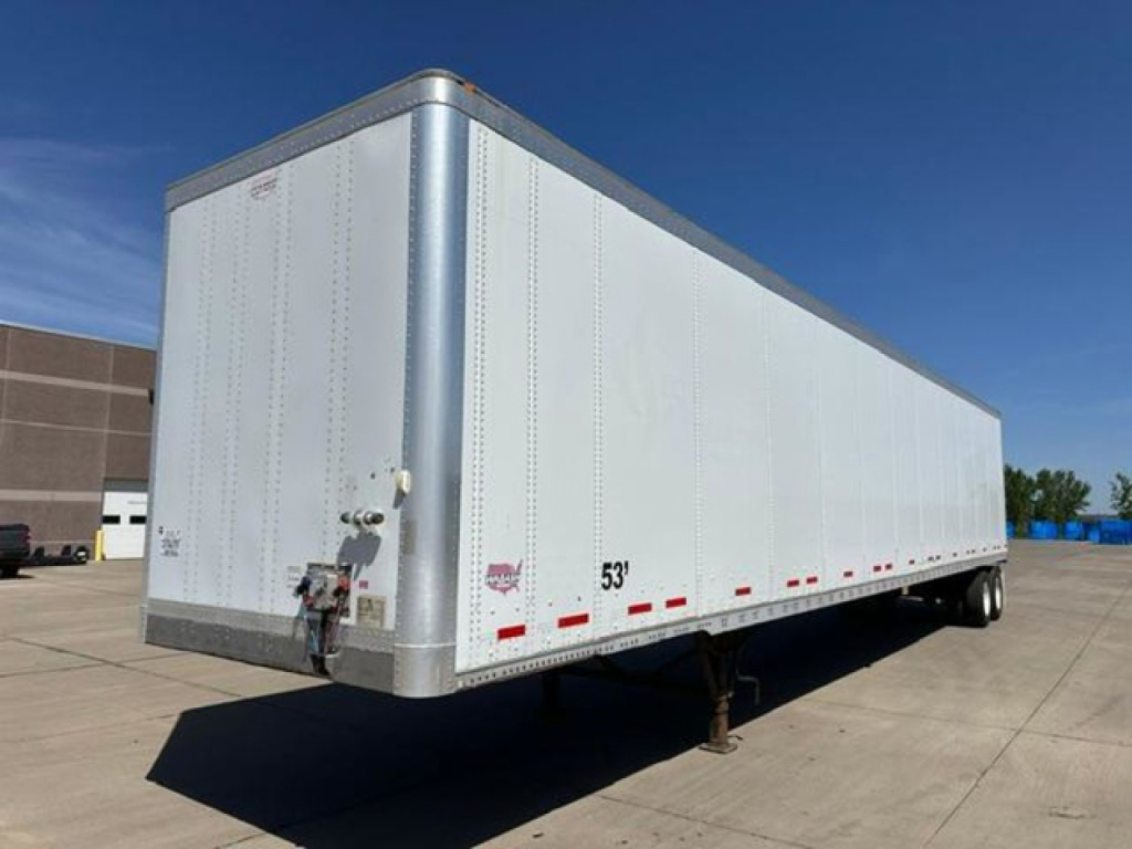 53' Wabash dry van trailer showing rear swing door, hitch, and jack stand on a concrete lot.