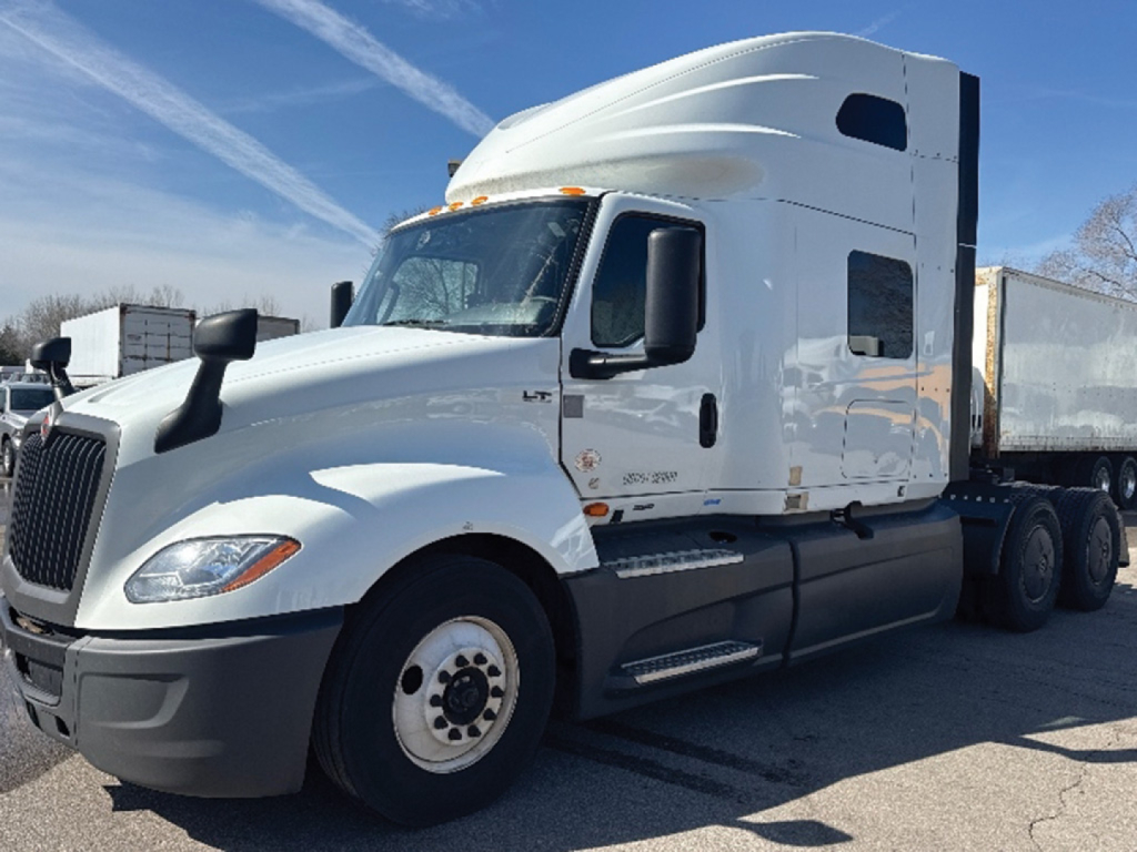 Truck cab and trailer in a parking lot with International LT625 model badge on the side.