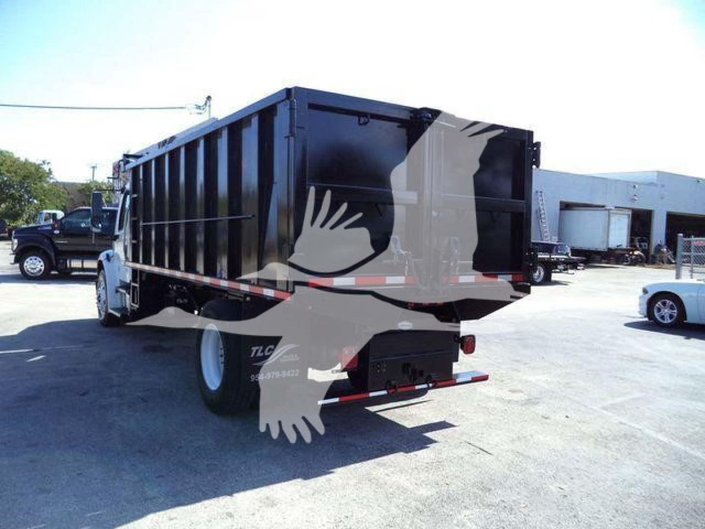 Dump truck bed of a 2017 Freightliner M2 106 with rear view showing black dump body and taillights.