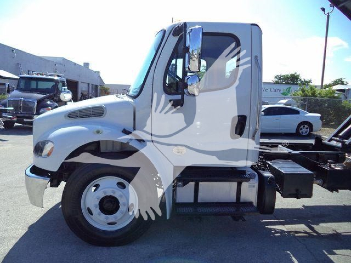 Side view of a white Freightliner M2 106 cab with exposed chassis and wheel, dump truck configuration, stock number THY4750FM.