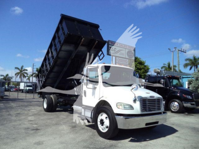 White Freightliner M2 106 dump truck with raised bed in a parking lot, stock number THY4750FM.