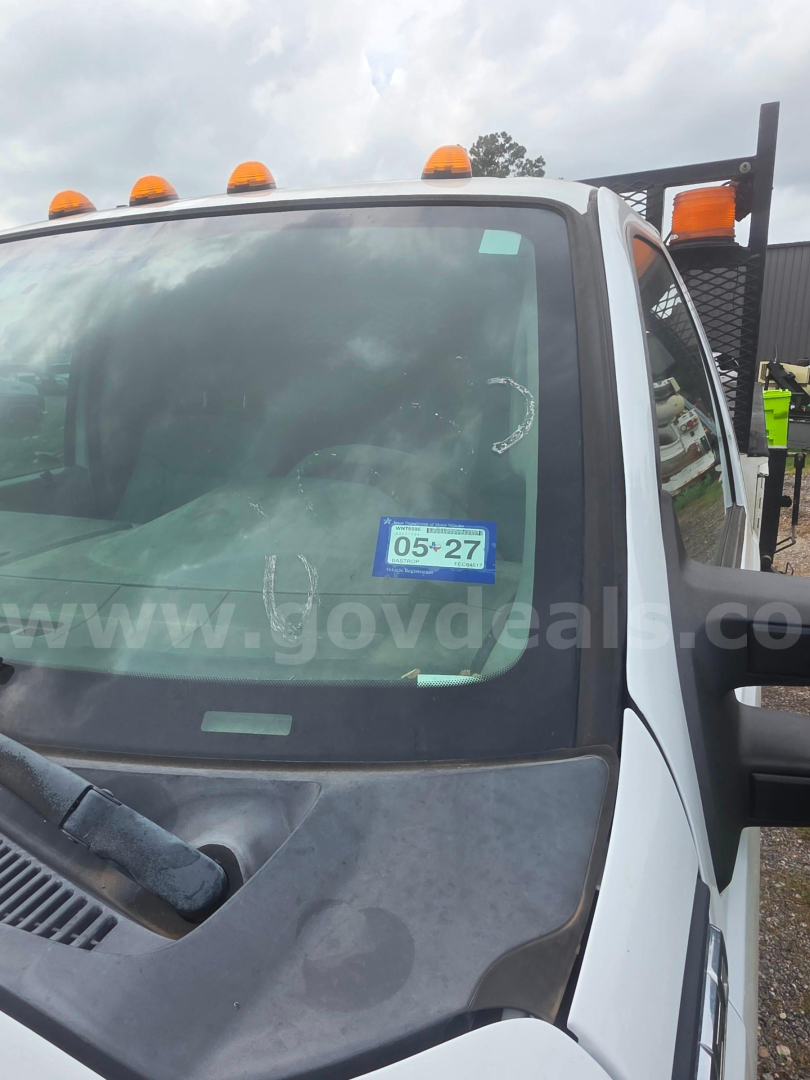 Ford F-350 cab view showing windshield with inspection sticker and orange clearance lights on roof.