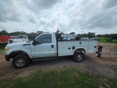 Ford F-350 utility service truck side view showing Utility bed with compartments and equipment rack.