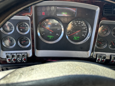 Kenworth T660 dashboard showing multiple gauges including speedometer and tachometer; steering wheel partial view.