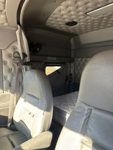 Kenworth T660 truck interior cabin area with quilted upholstery and sleeper berth in view.