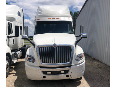 International LT625 truck front view showing grille, headlights, and chrome bumper in a lot.