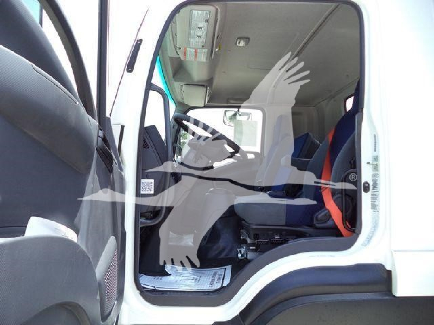 Isuzu FTR truck cab interior showing entry door and driver's seat.