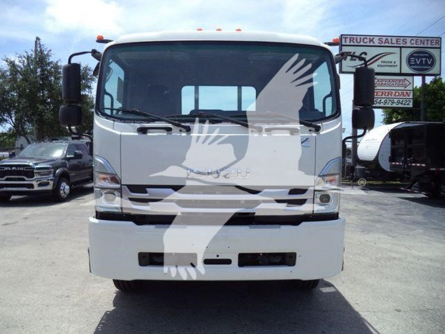 Isuzu truck front view showing cab and bumper with large windshield and side mirrors.