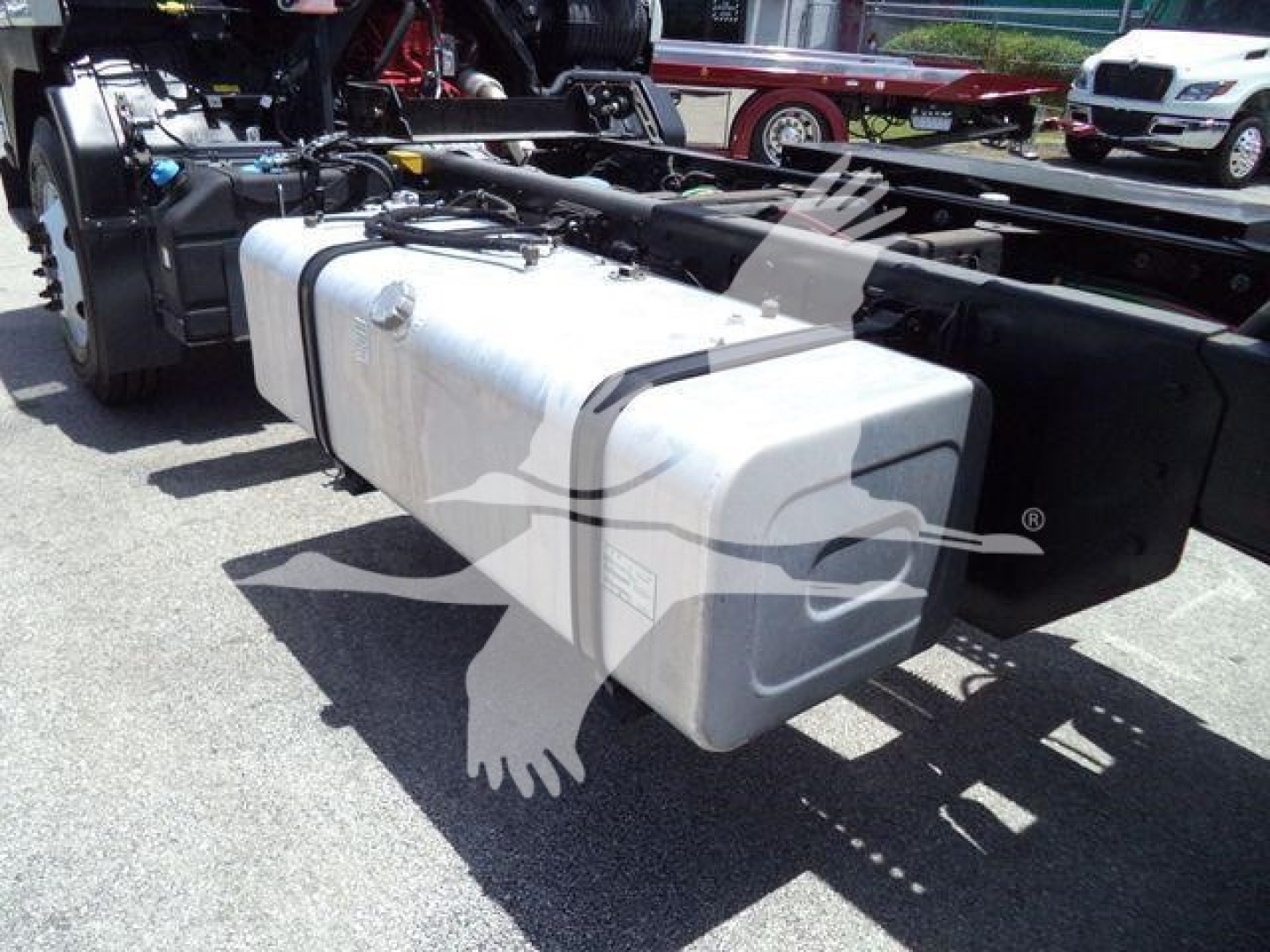 Isuzu FTR chassis showing large dual aluminum fuel tanks and frame undercarriage.