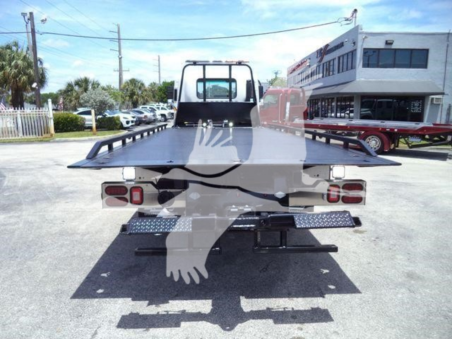 Isuzu FTR rollback truck bed seen from rear view showing flatbed and taillights.