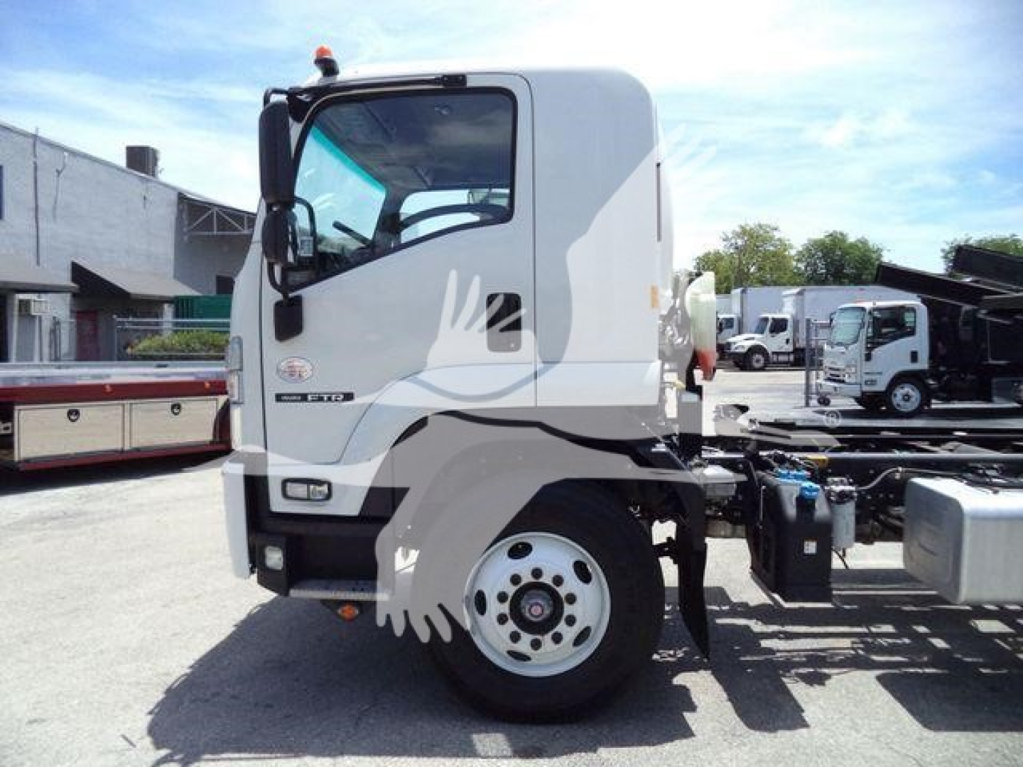 Isuzu FTR truck cab with empty chassis showing front wheel and side mirror, inspection of cab and frame