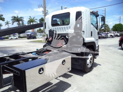 Isuzu FTR truck in service body configuration with tow/rollback equipment, side view showing cab and chassis.