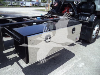 Isuzu truck with a large rectangular metal cargo box mounted near the chassis, visible cab and wheels in background.