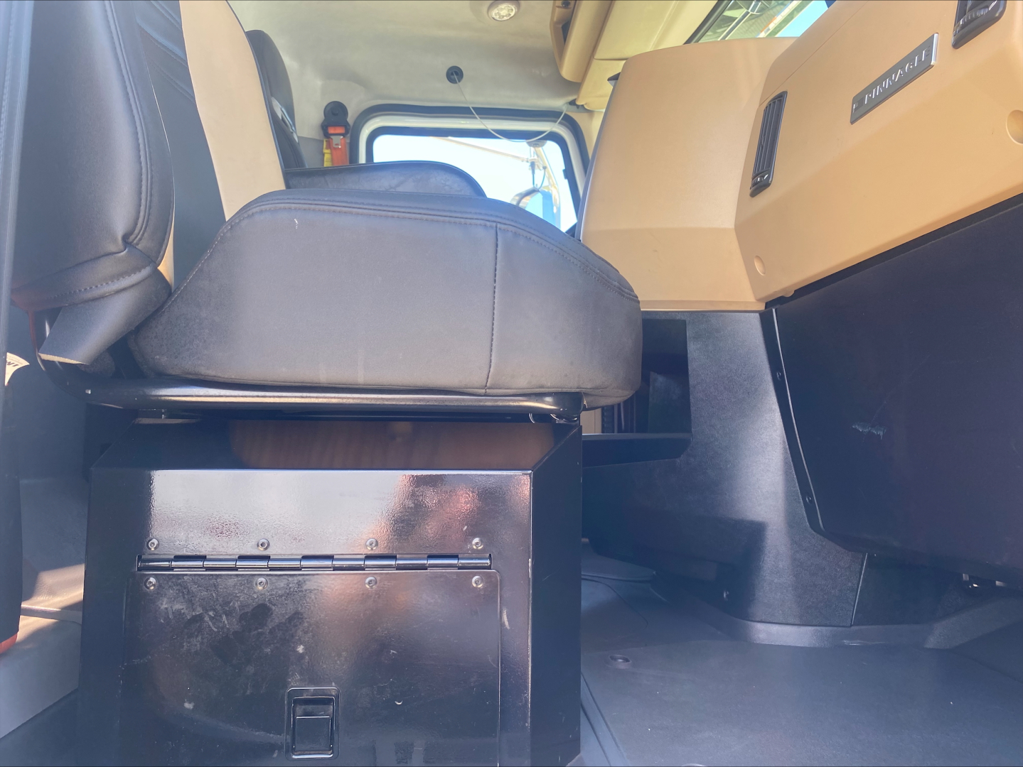 Mack PI64T truck interior showing driver seat and center console with metal storage drawer.
