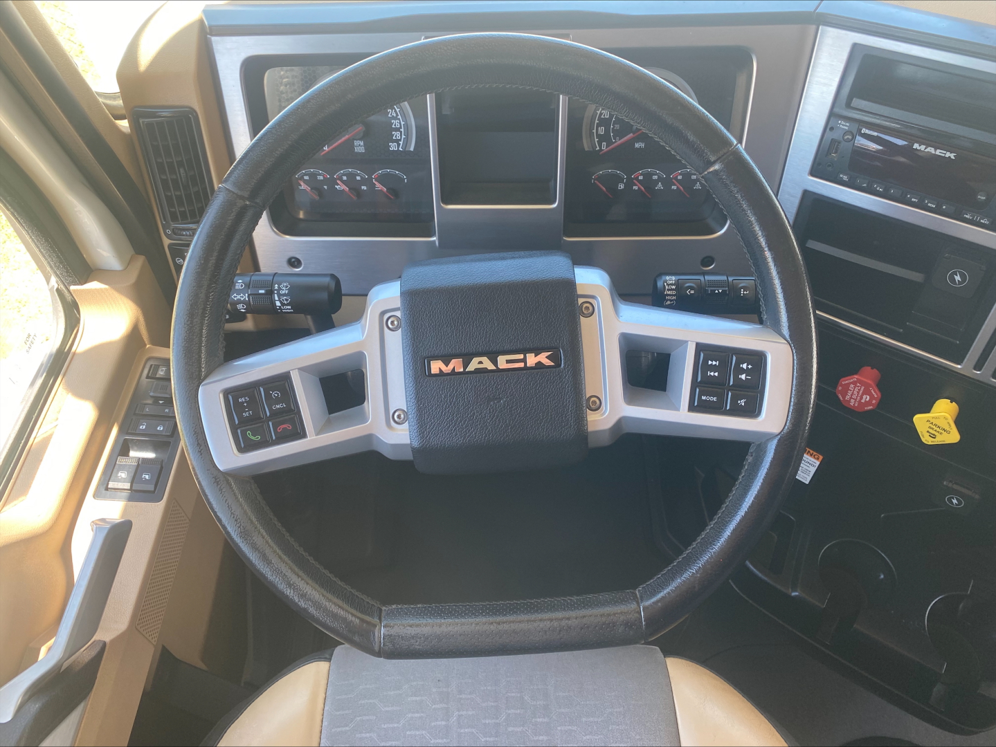 Mack PI64T steering wheel and dashboard with center Mack logo and control buttons.